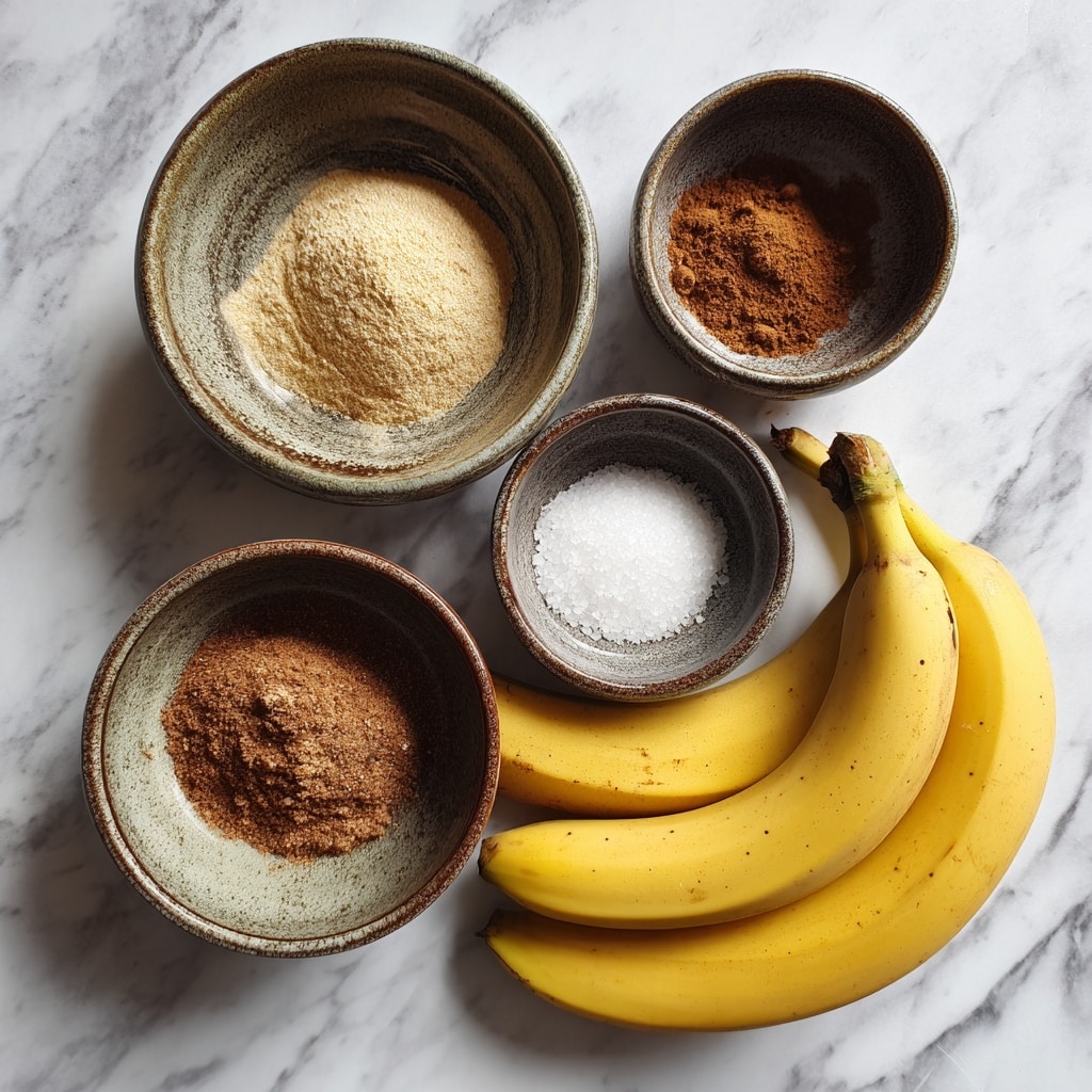 A white bowl filled with a single layer of round, golden-yellow banana chips that have a light brown toasted center. Each chip is coated with a fine dusting of white sugar and cinnamon powder, giving a slightly grainy texture on the surface. The chips are placed on top of a white cloth inside the bowl. The bowl is set on a white marbled surface. photo taken with an iphone --ar 4:5 --v 7