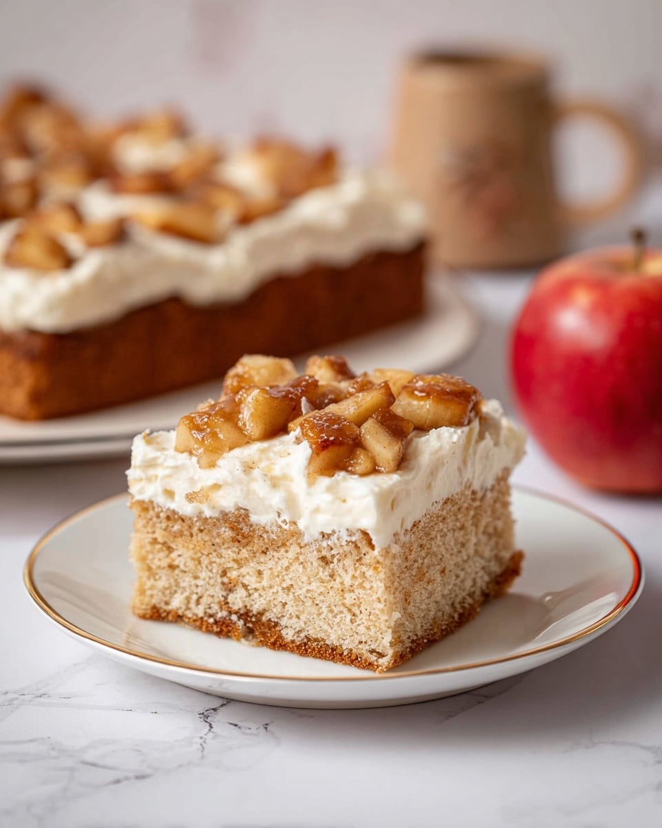 Two glass bowls with light brown cake batter are on a white marbled surface. The bowl on the left shows the batter being mixed with a metal whisk by a woman's hand, with some dry flour still visible on top, creating a lumpy texture. The bowl on the right shows the batter fully mixed and smooth, with a white spatula partially visible stirring the batter. Around the bowls, there are bright red apples and small white cups on a wooden board, adding color contrast. The scene feels warm and homey. Photo taken with an iphone --ar 4:5 --v 7