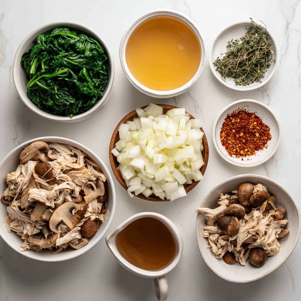 The image shows a white bowl filled with creamy soup. The soup has a light beige color as the base layer, with soft pieces of white shredded chicken mixed in. There are medium-sized brown mushroom slices spread on top, some slightly glossy with moisture. Dark green spinach leaves float around the ingredients, adding color contrast. Small specks of black pepper and fresh green thyme sprigs sit on the surface, giving texture and detail to the creamy liquid. The bowl rests on a white marbled surface, and the lighting highlights the smooth and rich texture of the soup. photo taken with an iphone --ar 4:5 --v 7