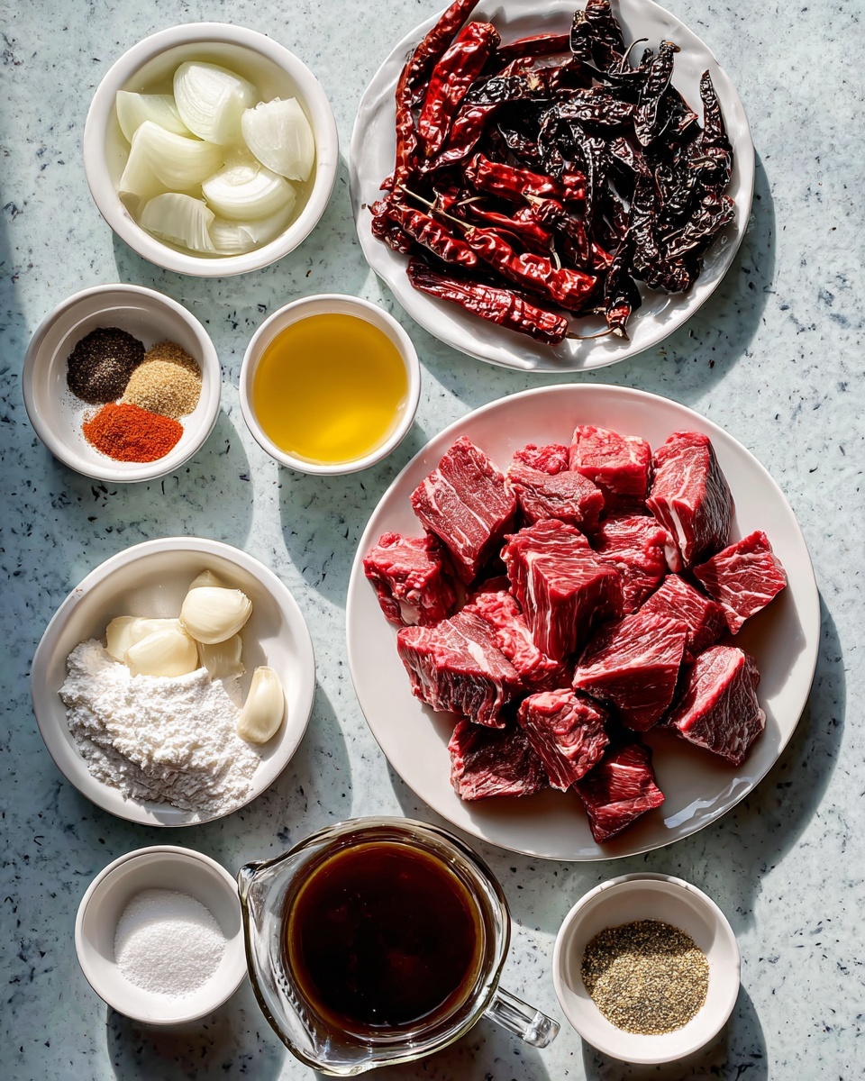 Beef Chile Colorado Recipe 4 The image shows an overhead view of several white plates and small bowls arranged on a white marbled surface, each holding different ingredients. One large white plate in the center holds many bright red chunks of raw beef with white marbling. Above it, a white plate displays various dried chili peppers in different shades of red and black. To the left, a white bowl filled with large white chunks of onion sits beside a small glass bowl of white flour and a small bowl with three peeled garlic cloves. Above these, there are three small white bowls containing spices, salt, and a yellow liquid, along with a clear glass pitcher filled with a dark brown liquid. The ingredients are neatly arranged in a colorful, textured layout. photo taken with an iphone --ar 4:5 --v 7