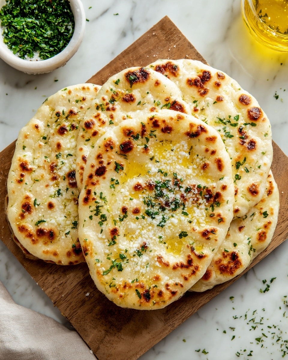 The image shows a stack of two thick, golden-brown flatbreads on a simple white plate. Each flatbread has a slightly crispy, browned surface with small green herb pieces sprinkled throughout, giving them a fresh look. The top flatbread is garnished with a small bunch of green parsley in the center. The plate sits on a white marbled surface with soft natural light highlighting the textures of the bread and herbs. Photo taken with an iphone --ar 4:5 --v 7