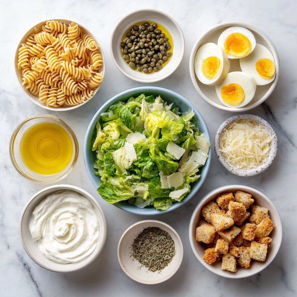 A white bowl filled with a creamy pasta salad featuring light beige spiral rotini noodles mixed evenly with bright green romaine lettuce pieces, coated in a smooth white dressing. Scattered on top are golden brown crunchy croutons and thin, pale shavings of cheese. The salad has a fresh and textured look with a sprinkle of black pepper adding specks throughout. The bowl sits on a white marbled surface with a beige cloth partially visible beside it and fresh romaine leaves nearby. photo taken with an iphone --ar 4:5 --v 7