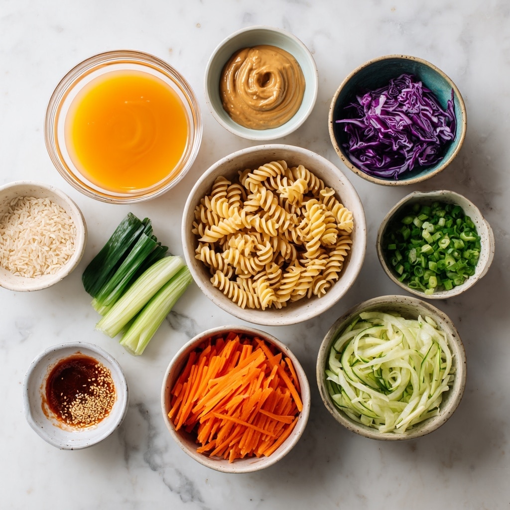 A large white bowl filled with a colorful pasta salad sits on a beige cloth on a white marbled surface. The salad has three layers: the bottom layer is light yellow rotini pasta spirals, mixed with thin, bright orange carrot strips; the middle layer has vibrant purple cabbage shreds that add a pop of color; the top layer is garnished with small green onion slices scattered across the salad, along with pale green cucumber chunks. Next to the bowl, a pair of dark brown chopsticks rest on the cloth. The photo taken with an iphone --ar 4:5 --v 7