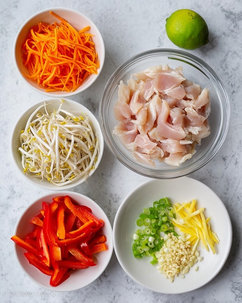 The image shows six dishes arranged on a white marbled surface. In the center is a clear glass bowl filled with pale pink slices of raw chicken. To the top left is a white bowl holding thin, bright orange carrot strips. Below it, another white bowl contains fresh white bean sprouts with tiny yellow tips. At the bottom left is a white bowl filled with red bell pepper strips. To the bottom right, a small white plate has finely chopped garlic, sliced green onions, and thin yellow ginger strips. At the top right corner, a whole green lime rests on the white marbled surface. The photo taken with an iphone --ar 4:5 --v 7