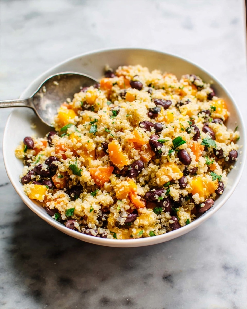 A clear glass bowl filled with a colorful mix of small grains that look slightly yellow, mixed with bright yellow corn, black beans, small red tomato pieces, and green bits of chopped herbs, all evenly spread throughout the bowl with a wooden spatula resting on the right side inside the bowl. The bowl is placed on a white marbled texture surface. photo taken with an iphone --ar 4:5 --v 7