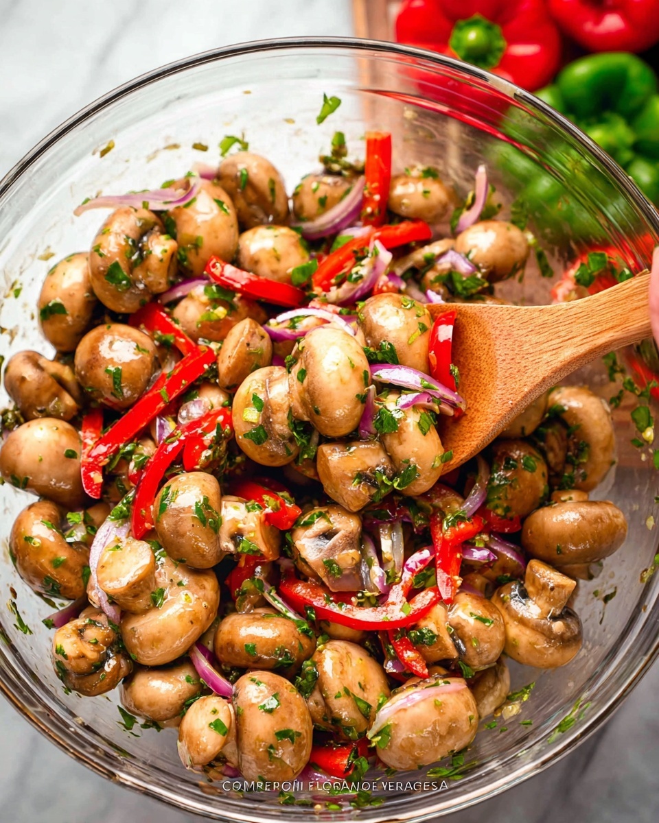 The image shows a close-up of a bowl filled with whole white mushrooms mixed with thin slices of bright red bell peppers and light purple onion strips. The mushrooms are glossy and plump, surrounded by scattered green chopped herbs and some small yellow mustard seeds, creating a fresh and colorful look. The bowl is white, placed on a white marbled surface, and some bright green leafy herbs can be seen blurred in the background. The overall feel is fresh and vibrant, with a mix of smooth mushroom texture and crisp vegetable slices, photo taken with an iphone --ar 4:5 --v 7