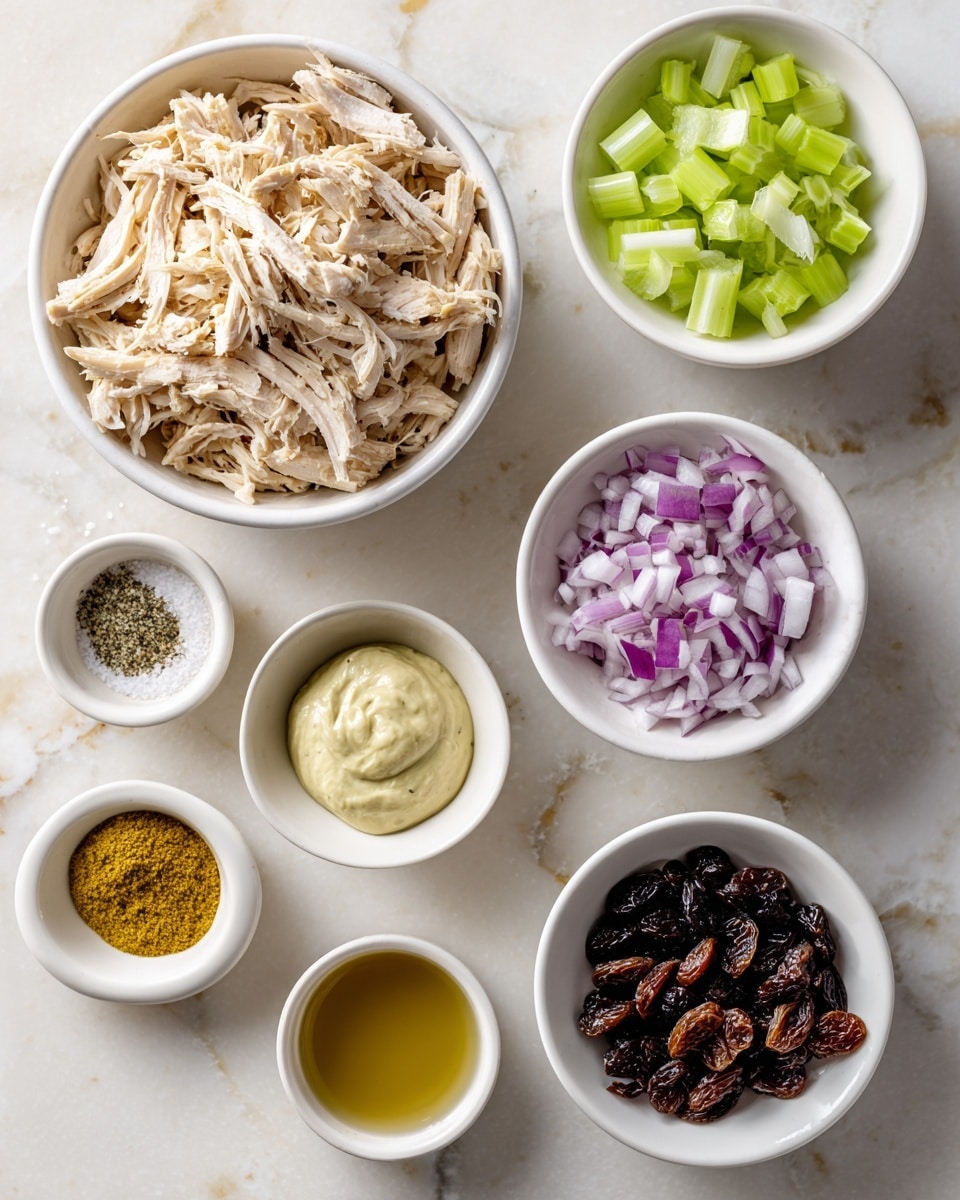A white bowl filled with shredded chicken sits on the top left, showing light beige, tender strips of meat. To the right, a white bowl with small green celery pieces, adding a fresh contrast. Below the shredded chicken, a white bowl holds finely chopped red onion with its purple and white bits. Next to it on the right is a smaller white bowl filled with dark brown raisins. Below the raisins, a dollop of creamy light beige avocado or olive oil mayo rests in a small white bowl. Moving downward and to the left, a tiny white bowl contains a mound of golden yellow curry powder. In the center bottom, a white bowl holds sea salt and black pepper arranged side by side. The last item is a white bowl on the bottom right with light amber apple cider vinegar. The bowls are placed on a white marbled surface, creating a clean and fresh kitchen scene. photo taken with an iphone --ar 4:5 --v 7