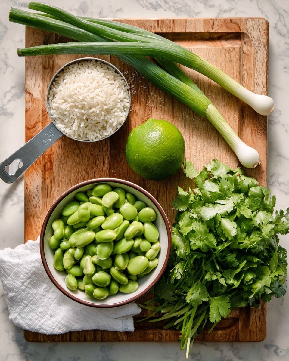 A wooden cutting board holds fresh ingredients neatly arranged: at the top left, a metal measuring cup filled with white rice grains; below it, two long green scallions with white roots; next to them, a bright green lime with a smooth texture; in the center, a white bowl with a brown rim filled with bright green edamame beans; to the right, a bunch of fresh cilantro on a folded white paper towel, showing leafy greens and thin stems. The surface beneath the board is a white marbled texture. photo taken with an iphone --ar 4:5 --v 7